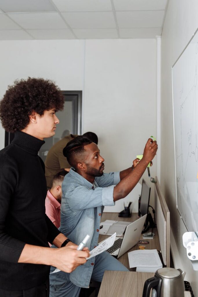 A diverse team working together on a project in a modern office setting, showcasing teamwork and innovation.