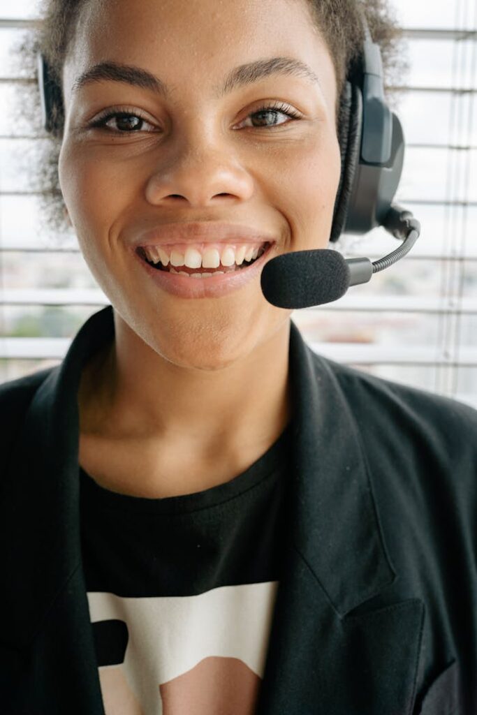 Smiling woman in a headset offering excellent customer service from indoors.